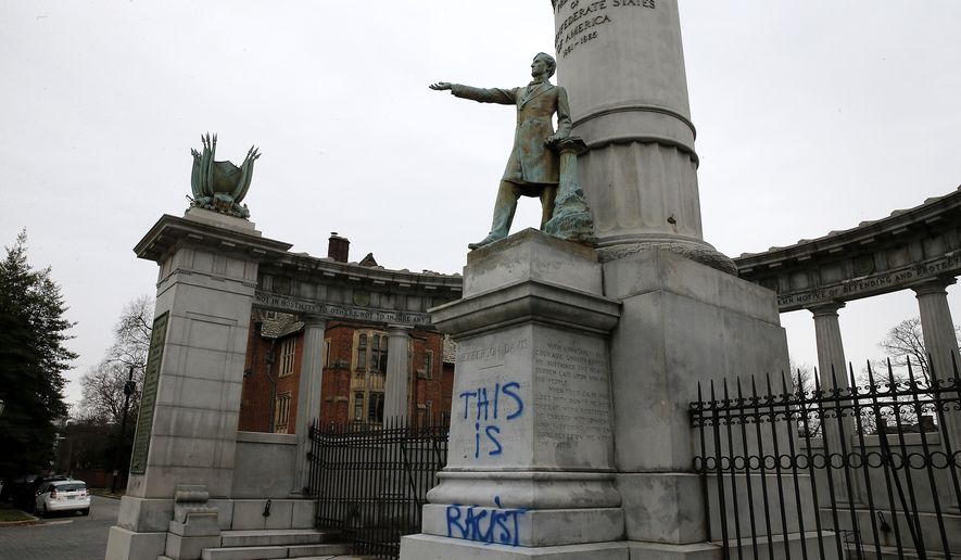 A statue of Confederate president Jefferson Davis which had been vandalized with the phrase “this is racist.”