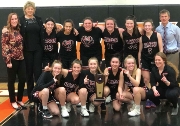 The+girls+basketball+team+hoists+their+regional+championship+trophy.+They+play+Friday+night+in+the+state+quarterfinal+against+Booker+T.+Washington.