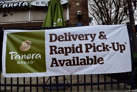 A large sign in front of Panera reads "Delivery and Pick-Up Available"