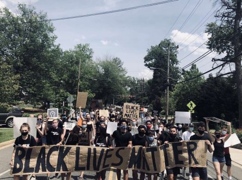 Mason students hold a "Black Lives Matter" sign in the BLM march in Falls Church.