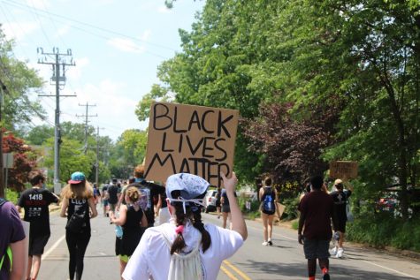 sign that says "black lives matter" in a crowd