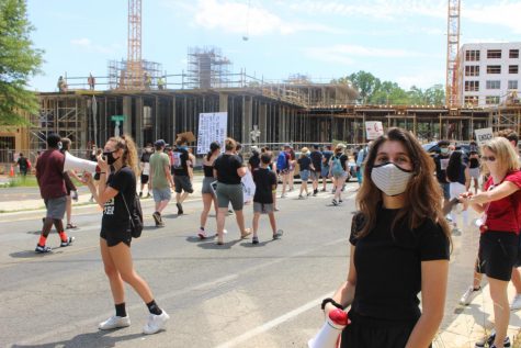 girl in mask in front of crowd