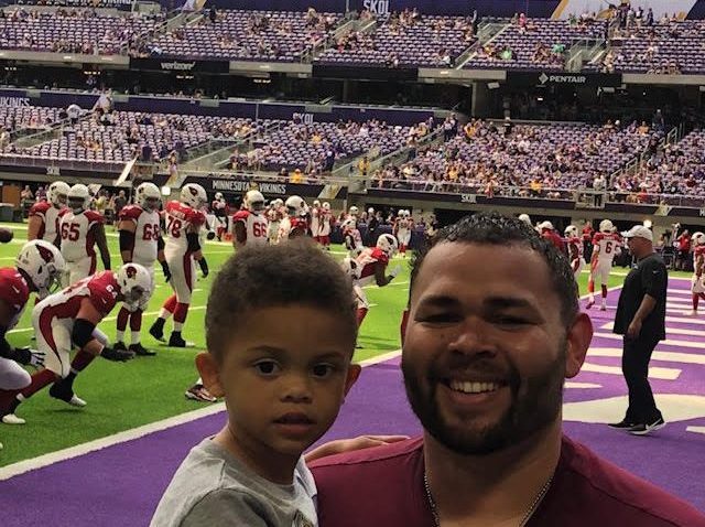Coach Wooten with his son at football game