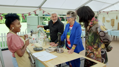 a contestant and the judges on the Great British Baking Show