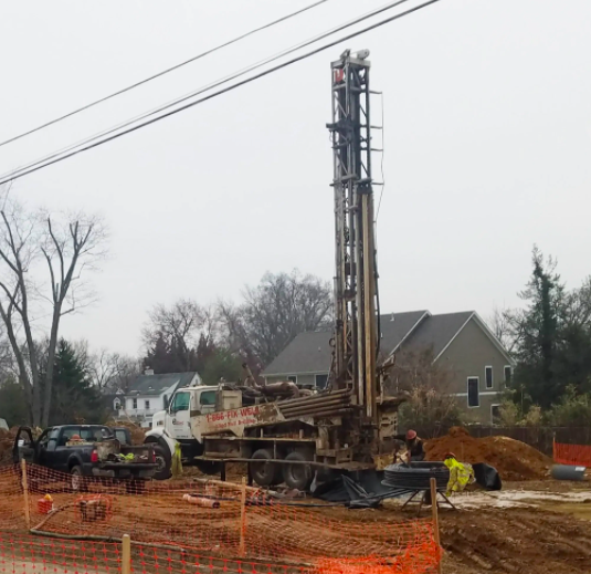 A large piece of construction equipment drilling a hole in a construction site.