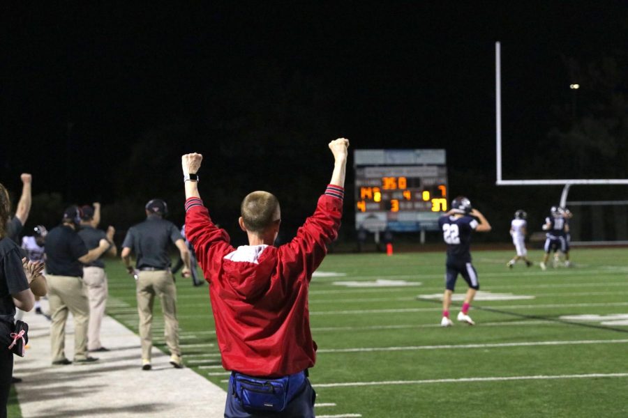 Athletic trainer Coach G celebrates as the Mustangs defense stops a hail mary pass on the Eagles fourth down. 