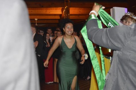 Senior Raissa Borges Souza excitedly runs up to accept her prom court sash.