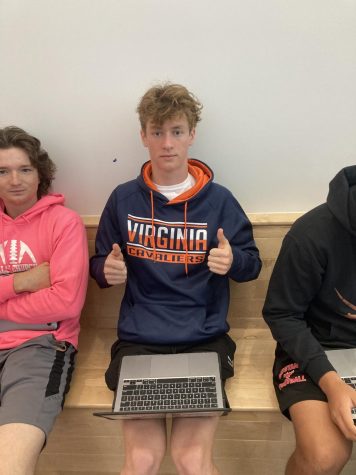 Griffin Harrison poses with two thumbs up in a Virginia hoodie.