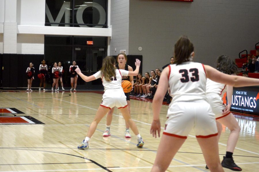 Mustangs work to keep the Tigers from scoring a basket. (Photo by Molly Moore)