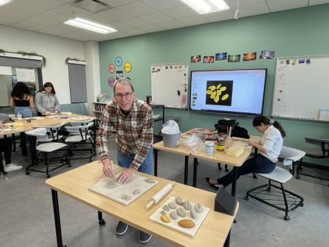 Mr. Robarge shapes and cuts clay for student use in a Stable Group work session (Photo courtesy of Ms Weston)