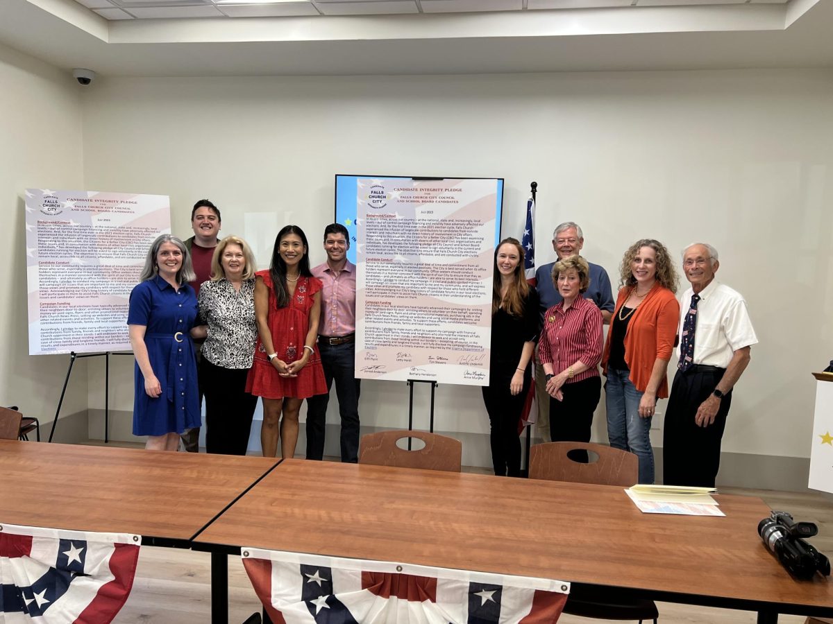 The candidates for the 2023 City Council and School Board elections pose next to the Candidate Integrity Pledge alongside working group members. Not present: Ross Litkenhous, Tim Stevens and Amie Murphy. (photo courtesy of Hal Lippman)