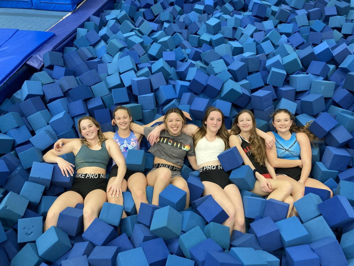 From+right+to+left%3A+Lauryn+Conner%2C+Sienna+Dawson%2C+Alexis+West%2C+Sessa+Tiffany%2C+Lauren+Banko+and+Lilah+Robertson+all+lay+in+a+blue+foam+pit+after+a+long+practice.+%28Photo+by+Natalie+Glees%29