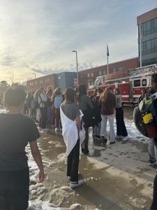 Students gather outside Meridian High School as emergency responders investigate the building. (Photo by Abby Crespin)