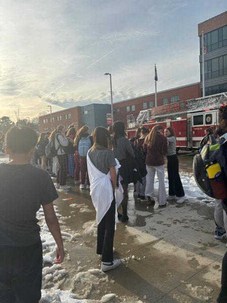 Students gather outside Meridian High School as emergency responders investigate the building. (Photo by Abby Crespin)