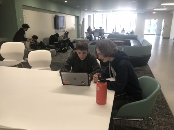 Greyson Potts and Liam Harper working in a common space. Working outside of the classroom can be fun, but also distracting. (Photo by Sesh Sudarshan)