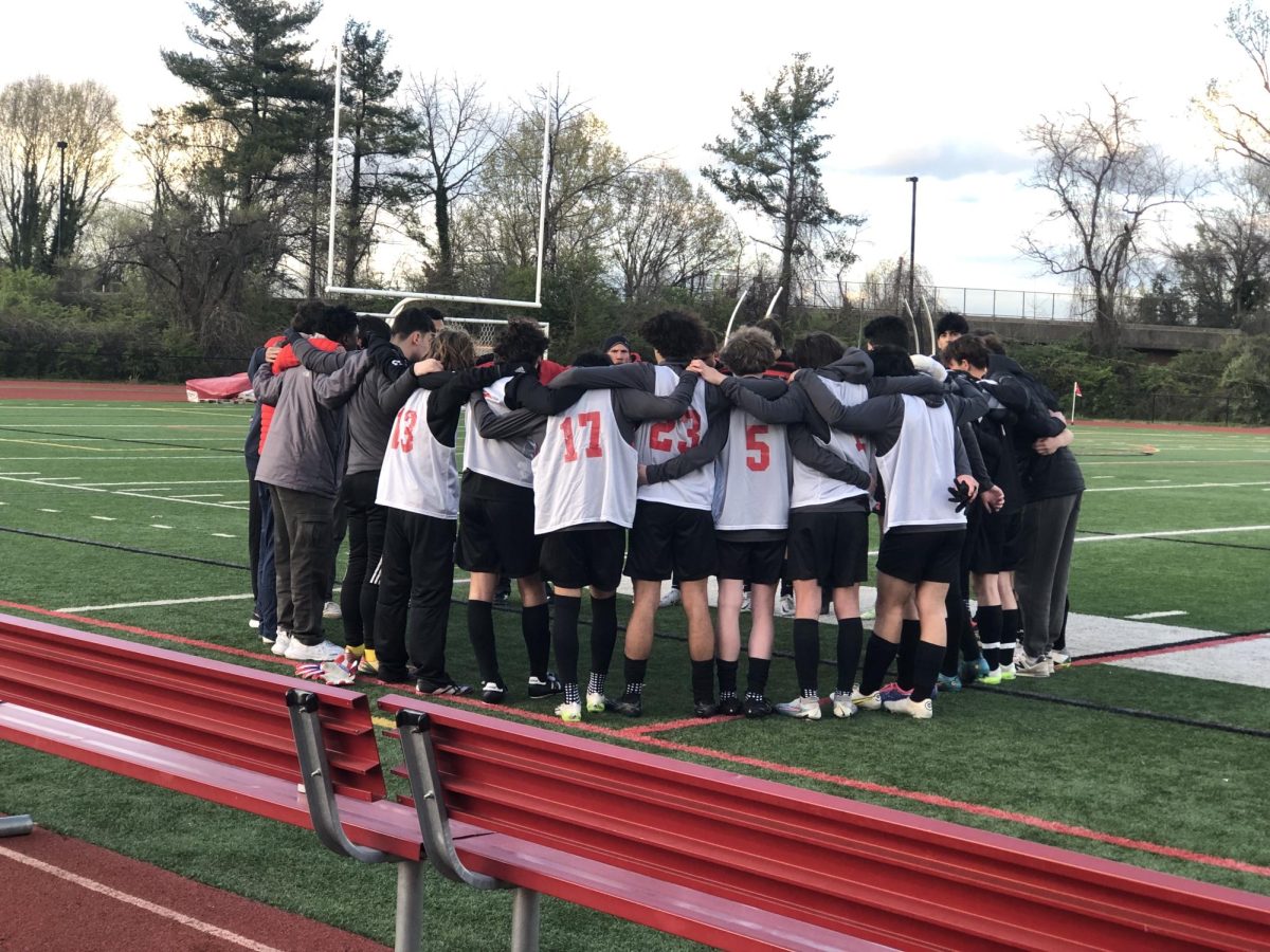 The Mustangs in a huddle before their game against Wakefield on Friday, April 5. (Photo by Sesh Sudarshan)