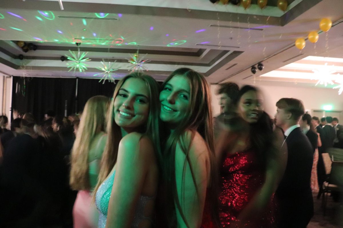 Seniors Ivy Anderson and Delia Paradiso smile for the camera at prom. (Photo by Rachel Grooms)