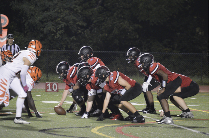 The Meridian Football Team lines up on offense, with quarterback Cruz Ruoff under center. (Photo by Dino Simcox)