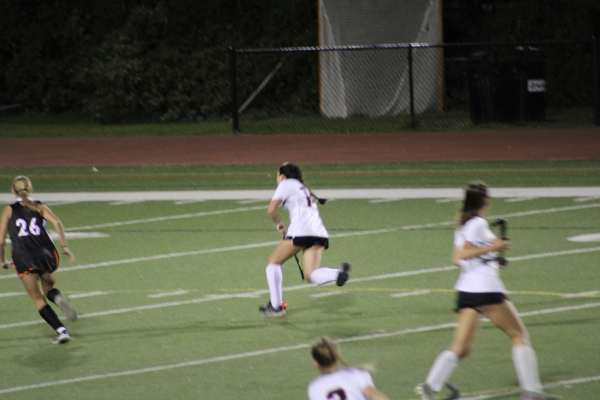 Senior Gia Khan intercepts a pass and sprints down the field on a breakaway. (Photo by Dino Simcox)