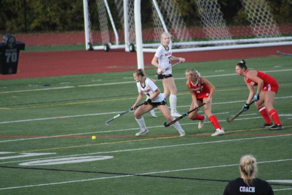  Junior Emma Flanagan evades Fauquier defenders. (Photo By Dino Simcox)