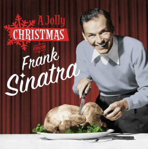 Frank Sinatra poses and carves a Christmas turkey while smiling at the camera (photo via Flickr)