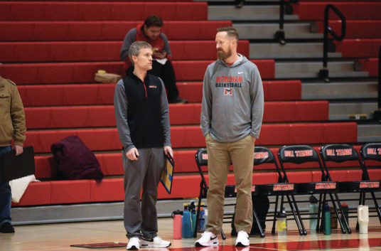 Coach Carrico and Coach Ryan talking courtside pregame. (Photo by Ryan Degnan)