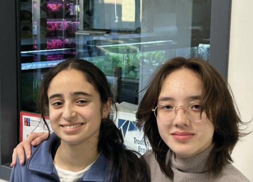 Anna Gray and Jasmine Cidon work together to make sure the fish in their care are healthy and well-fed. (Photo courtesy of Anna Gray and Jasmine Cidon)