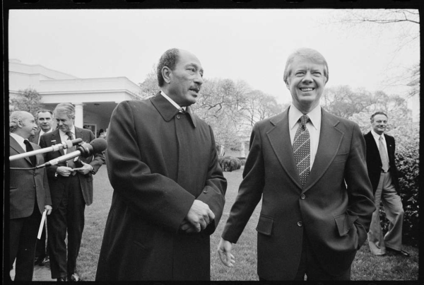  President Jimmy Carter smiles as he walks with Egyptian President Anwar Sadat at the White House (Photo via PICRYL)