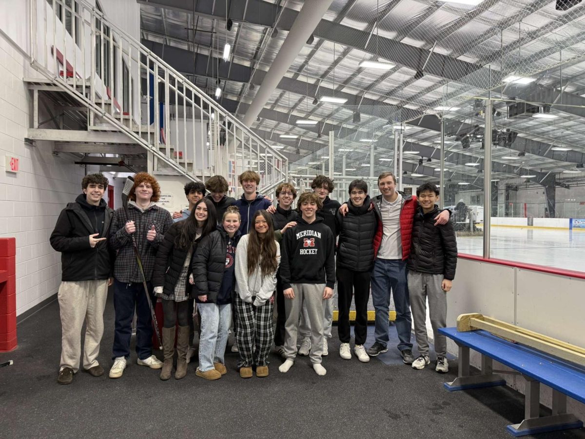 Meridian Hockey fans take picture after quarterfinal win with players Sam Ettinger and Ryan Degnan. (Photo via Ryan Degnan.)