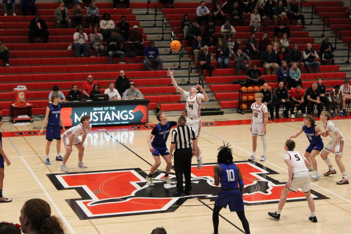 Senior John Alverson wins the tip-off to start the game. (Photo by Dino Simcox)