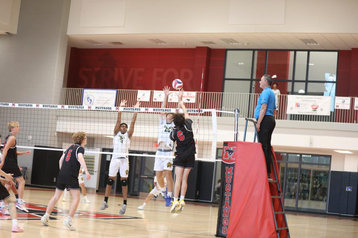 Sophomore Kaidan Hamner guards the net as Falls Church attempts to score. (Photo by Ryan Degnan)