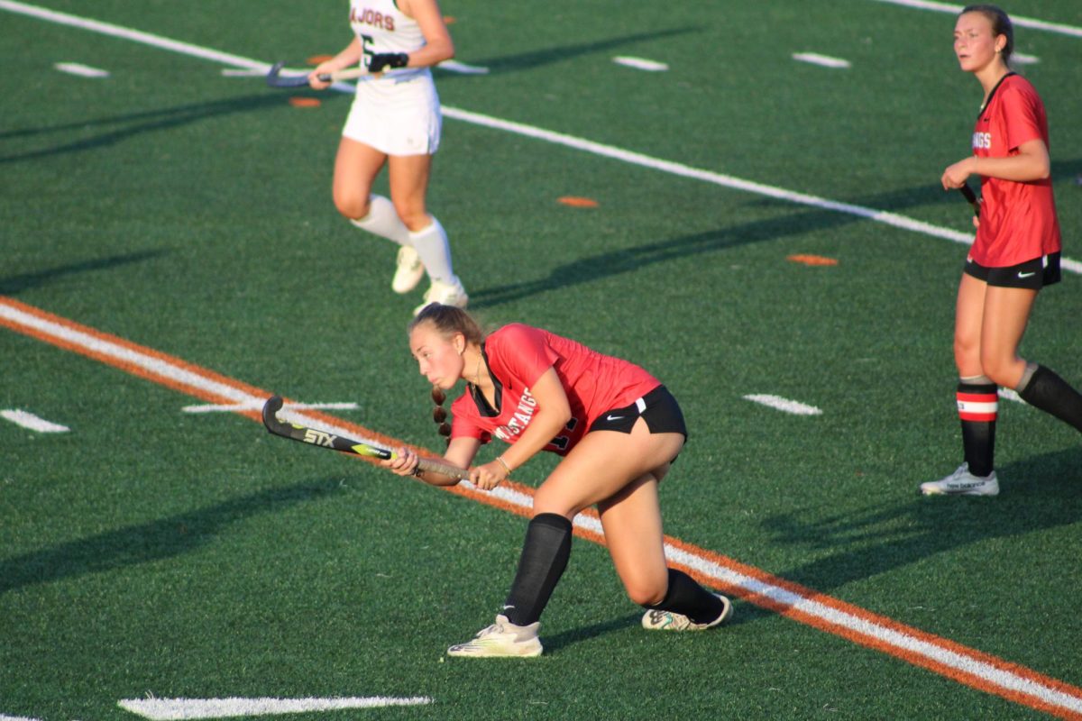 Junior Claire Hartenstein passes upfield in the first period (Photo by Dinos Simcox)