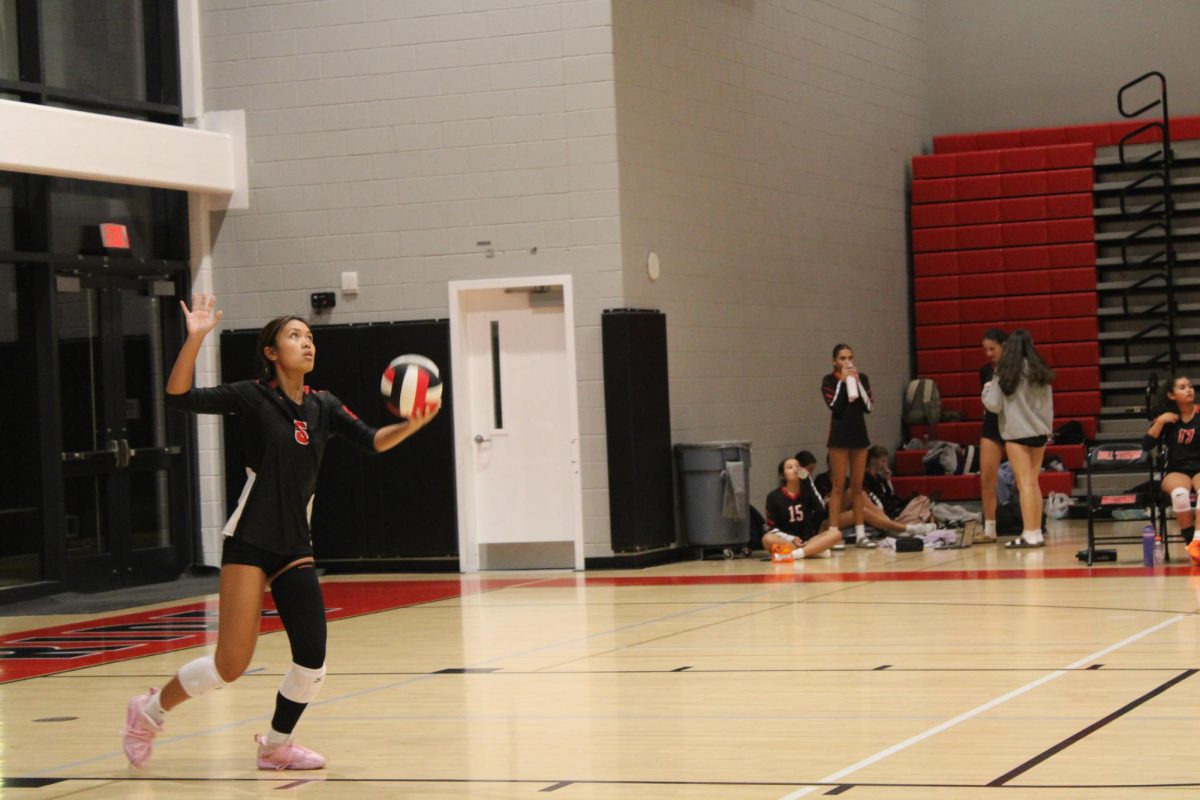 Senior Mai Nguyen serves the ball late in the 4th set (Photo by Nathaniel Landers)
