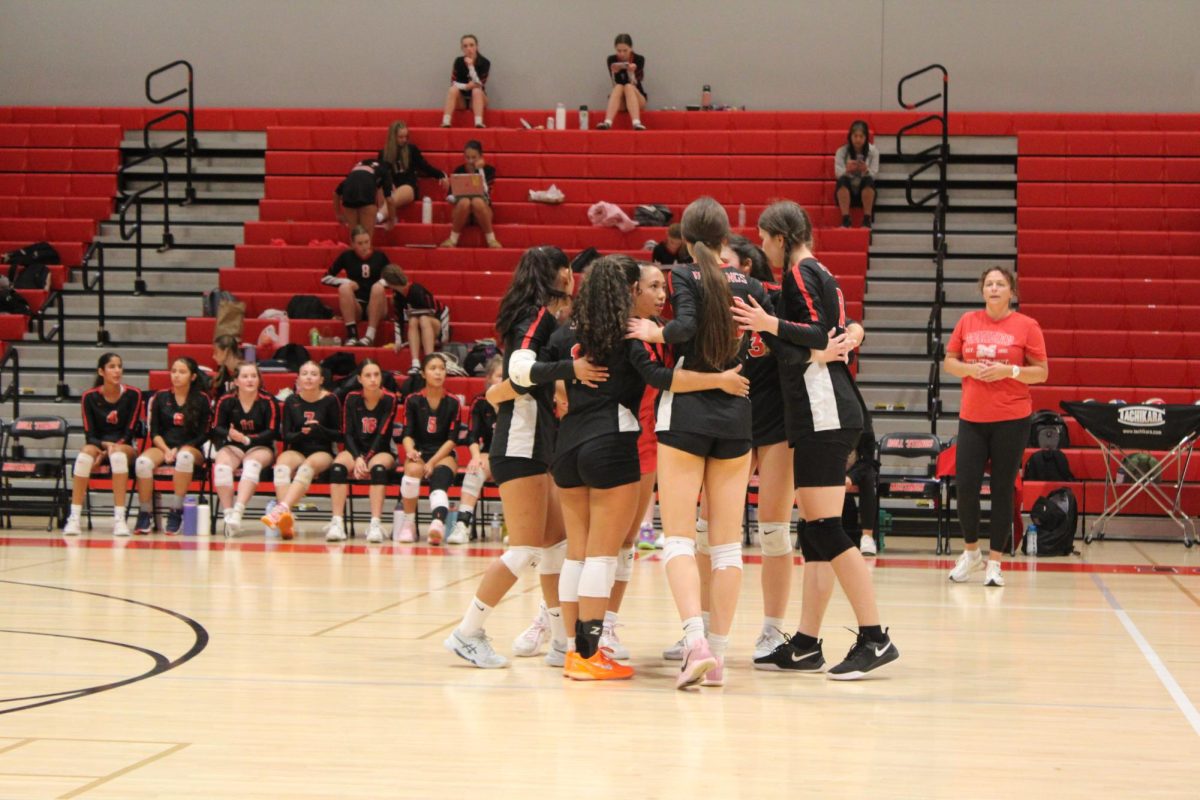  During the second set, junior Sophia Chan rallies her teammates before the next point. (Photo by Liliane Bonnenfant)