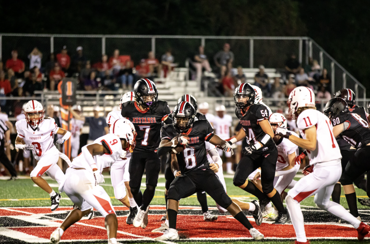 Senior Oumar Thompson runs the ball through the middle of the field. (Photo by Ryan Degnan)