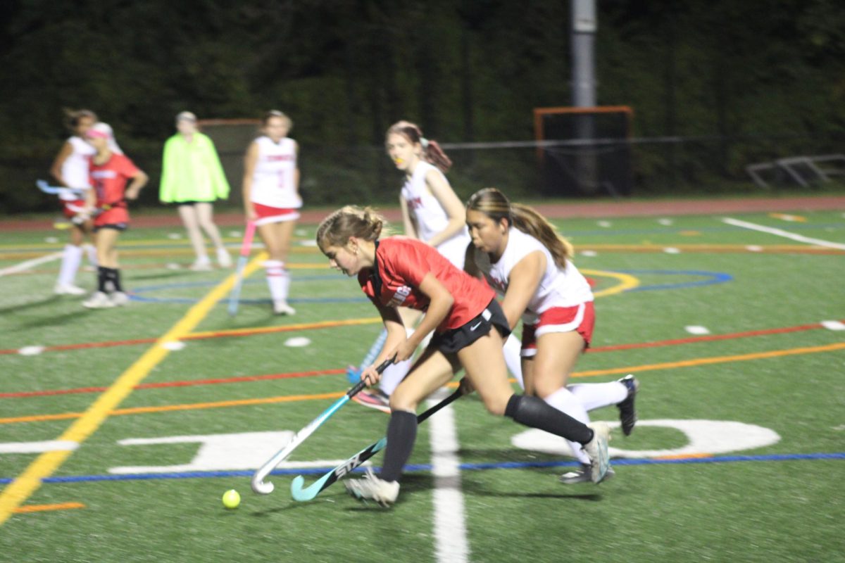 Sophomore Megan FitzGerald advances the ball towards the Eagles goal. (Photo by Nathaniel Landers)
