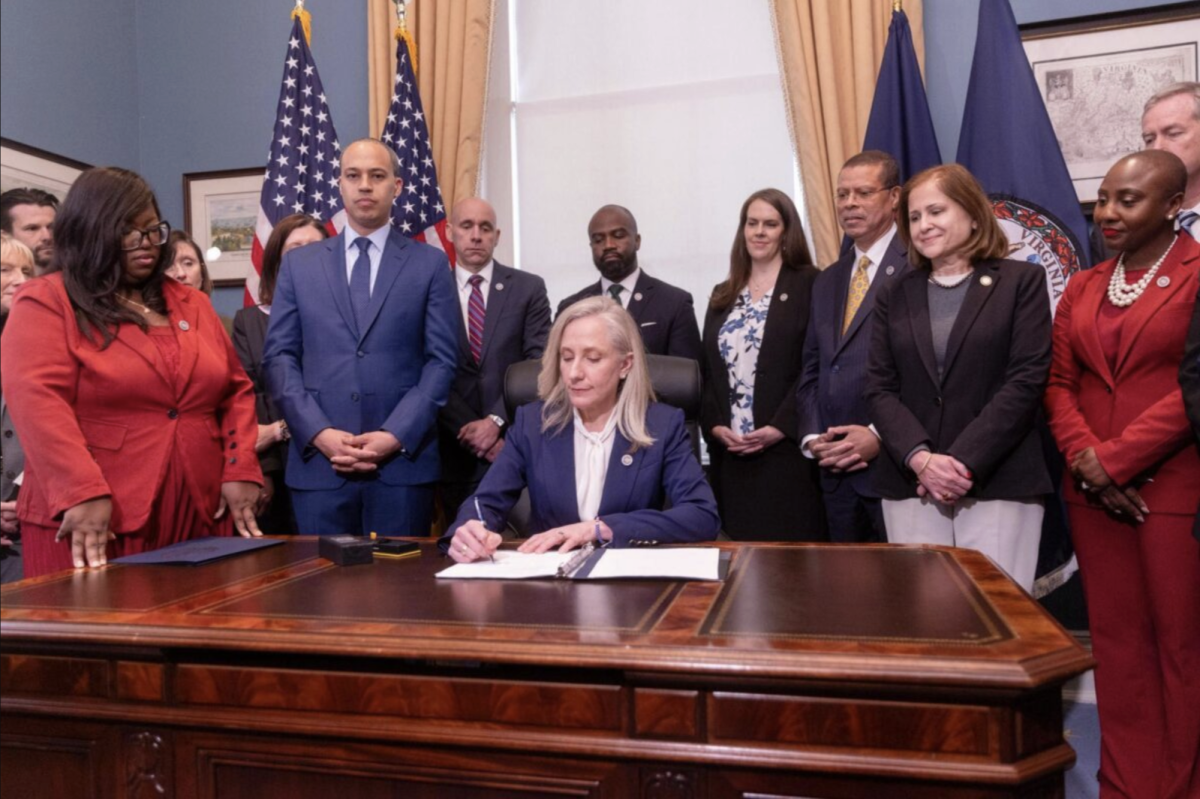Governor Abigail Spanberger signs executive orders on her first day in office. (Photo via shoredailynews.com)