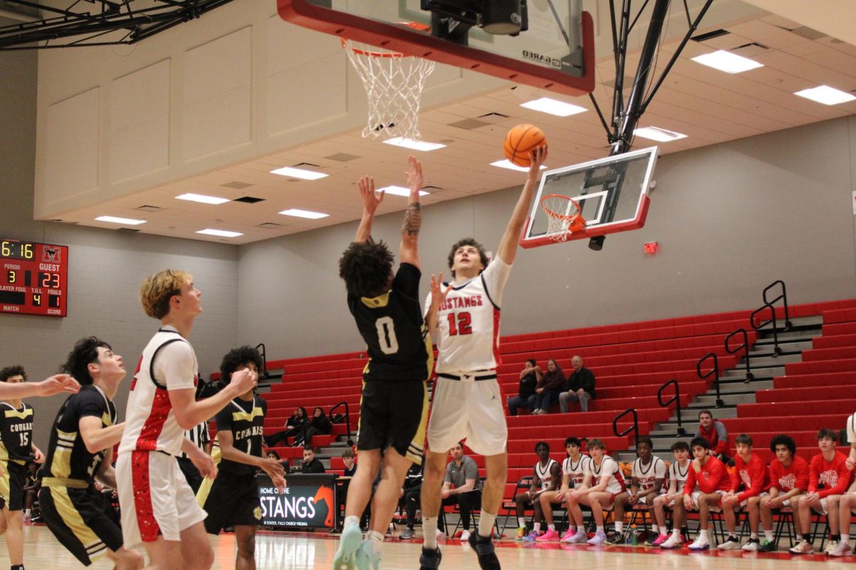 Senior, Emiglio Icabalceta shoots a layup in the third quarter against Manassas Park, extending the Mustangs lead. (Photo by Nathaniel Landers)