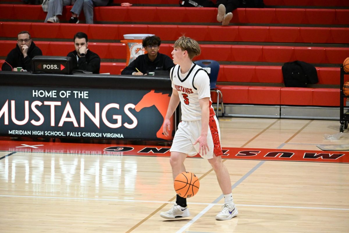 Senior Will Davis dribbles the ball up the court late in the second quarter against the Brentsville Tigers. (Photo by Nathaniel Landers)