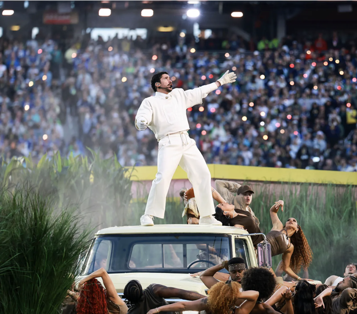  Bad Bunny dances on top of a car surrounded by backup dancers. (Photo via The New Yorker)