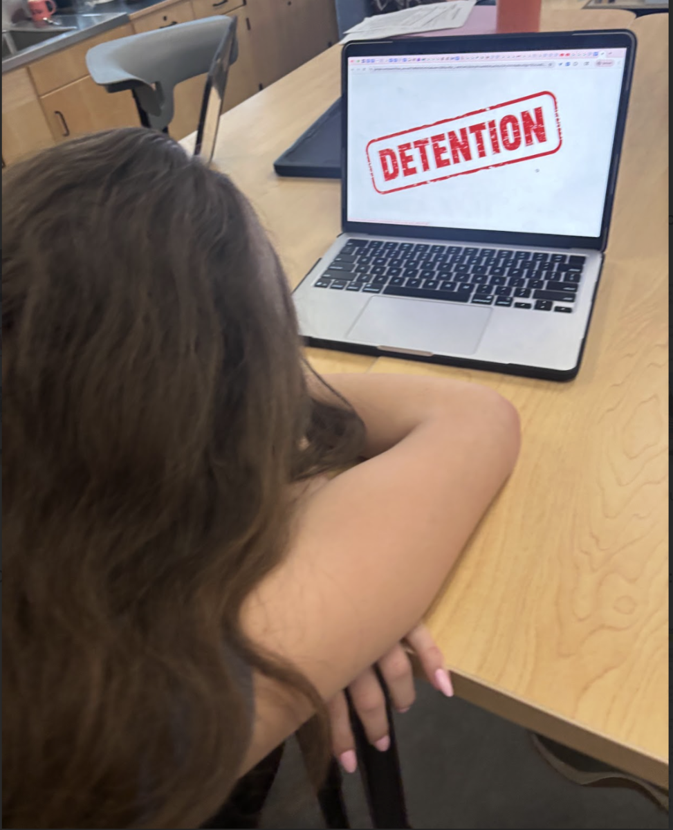Sophomore Layla Kozbelt receiving a mandatory detention in class. (Photo by Evi Stevens)