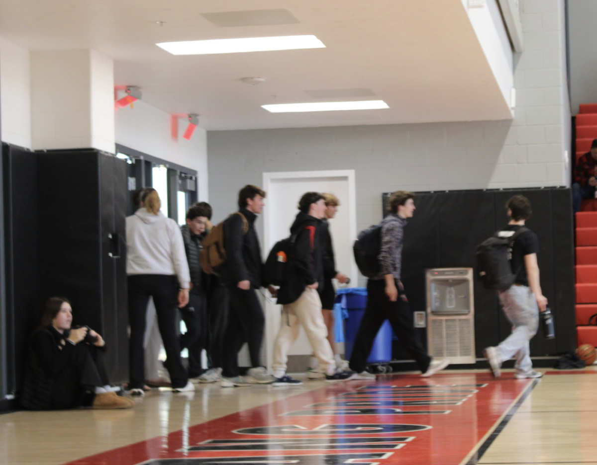 Seniors being ushered back into the gymnasium after attempting to leave.  (Photo by Sara Hadley)
