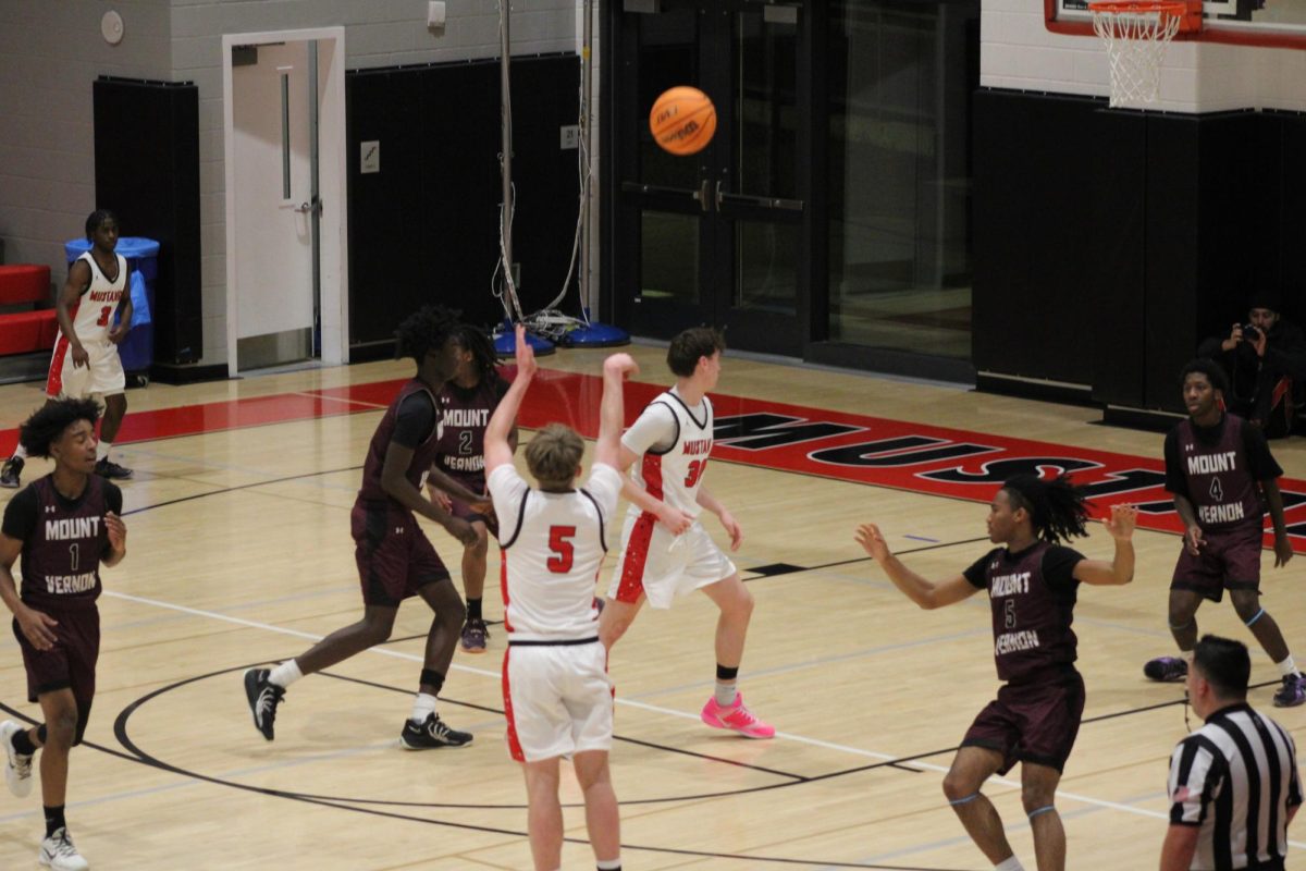  Senior Will Davis shoots a three-pointer in the season opener against Mt. Vernon. (Photo by Dinos Simcox)