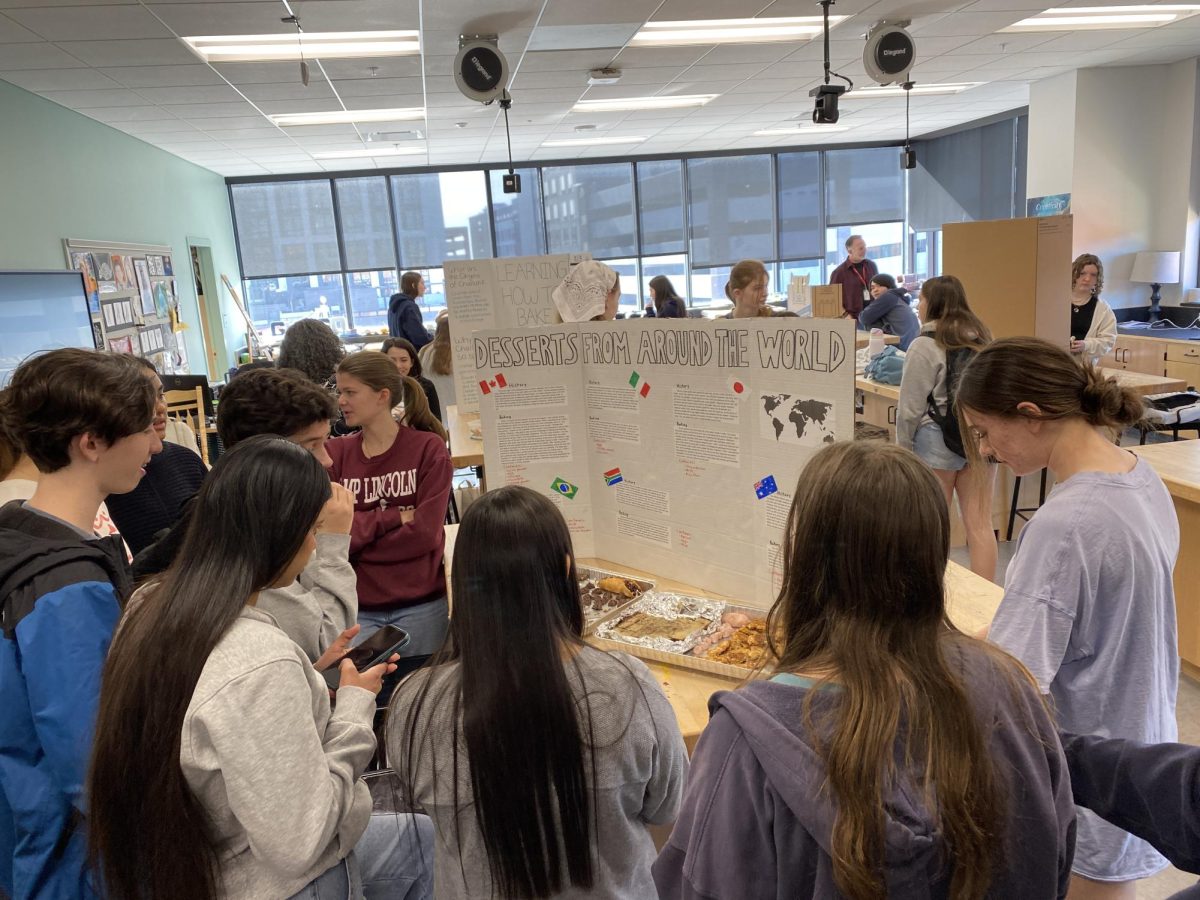 Students gather around trifold during the 2025 MYP personal project showcase (Photo courtesy of Chrissy Henderson)