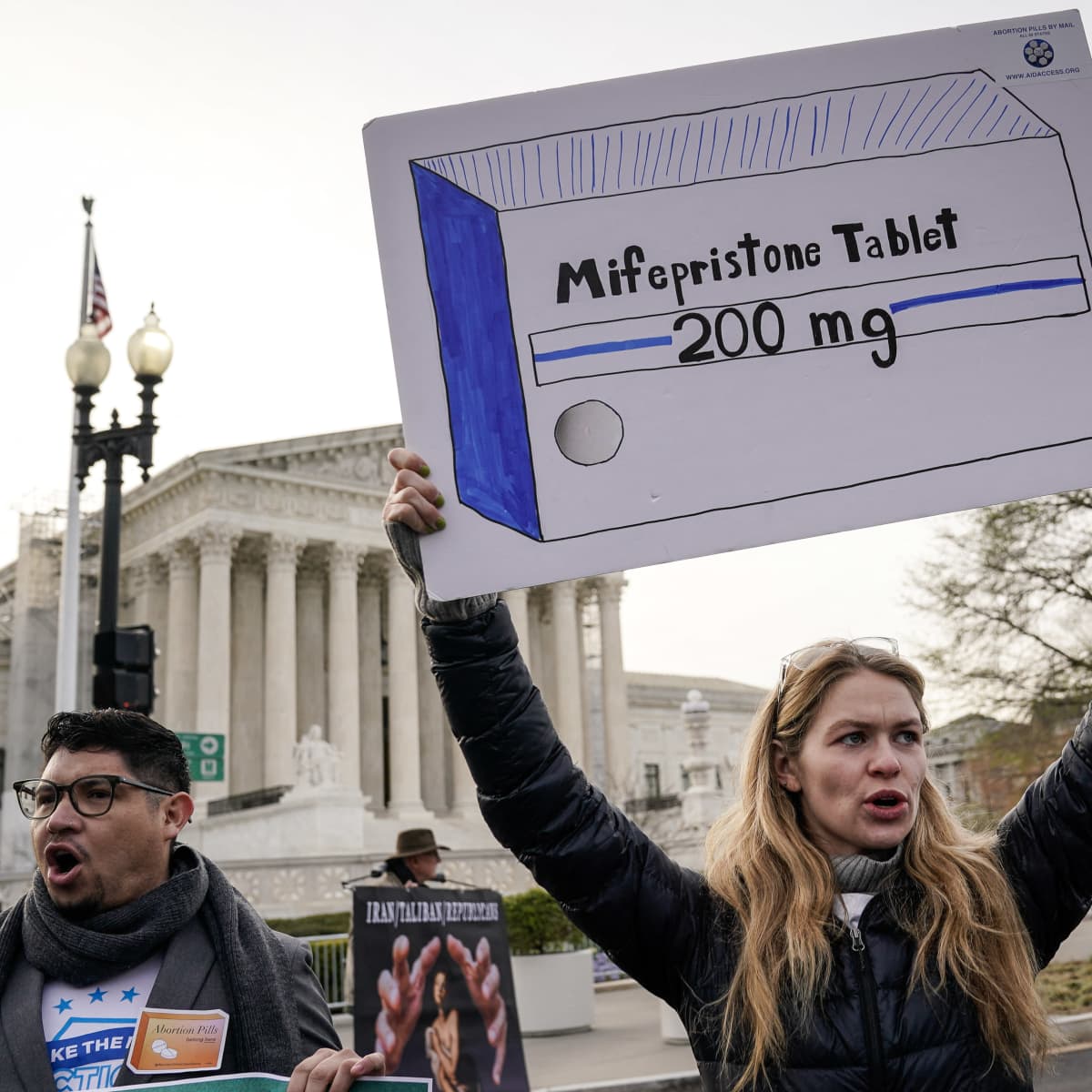 Protestors holding up signs of the 200mg abortion pill mifepristone 