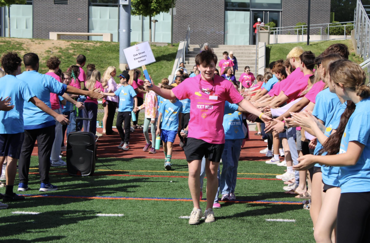 Junior Jetson Fitzpatrick leads attendees from Oak Street Elementary through a path of welcoming volunteers.