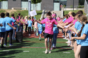 Junior Jetson Fitzpatrick leads attendees from Oak Street Elementary through a path of welcoming volunteers.
